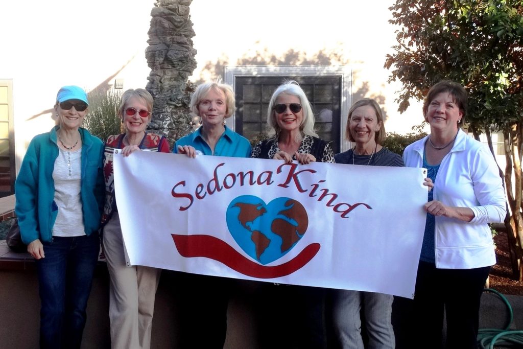 ladies holding a banner for Sedona Kind