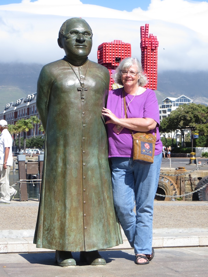 Lynn stands next to statue of Archbishop Tutu